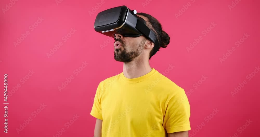 Surprise man experiencing virtual reality using VR glasses Surprise man experiencing virtual reality using VR glasses
