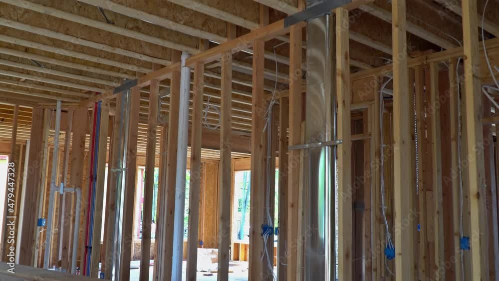 Building construction wood framing beams of a new house under construction Building construction wood framing beams of a new house under construction