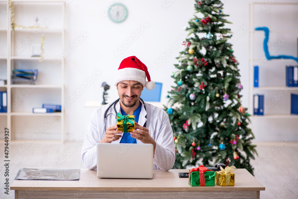 Young male doctor celebrating Christmas at the hospital Young male doctor celebrating Christmas at the hospital