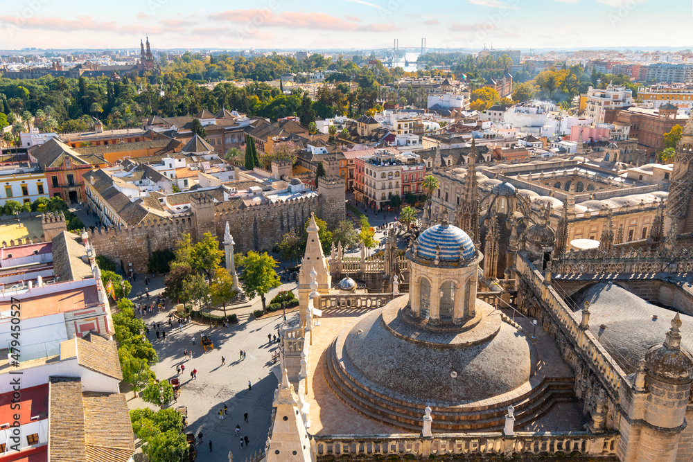 View of the Royal Alcazar, Plaza and Barrio Santa Cruz old town area from the Giralda Tower of the Seville Cathedral in Seville, Spain.
