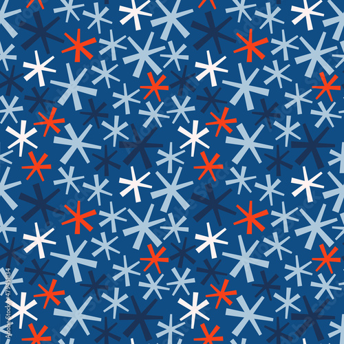 Seamless vector pattern with white, blue and red snowflakes. Festive winter background for wrapping, textile, print, fabric, decoration, etc.