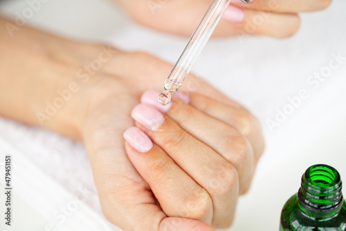 Closeup of beautiful woman hands getting manicure at home
