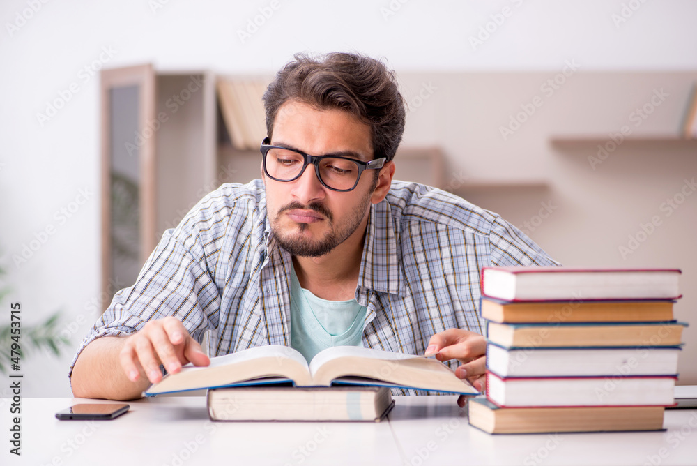 Young male student preparing for exams at home Young male student preparing for exams at home