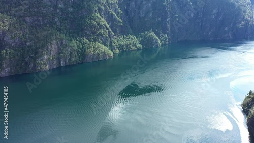 Flying over dronepilot and off dangerous  cliffs edge above Mofjorden in Norway photo