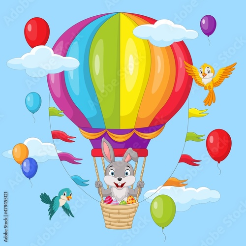 Cute little bunny and easter eggs flying in hot air balloon