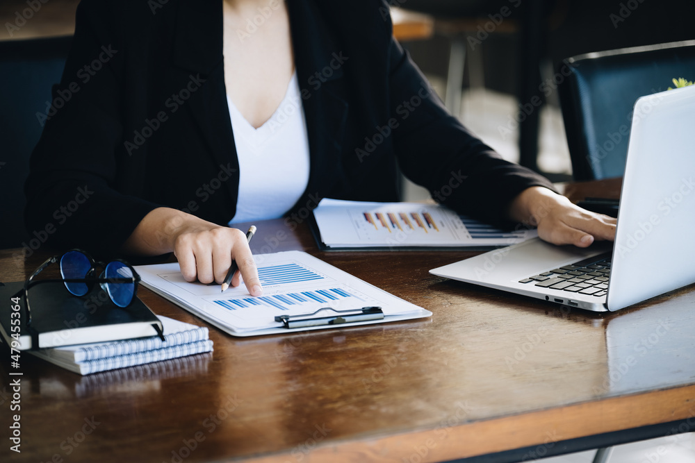 Investment concepts, businesswomen use document and computers to analyze stock markets, quantitative data collection, financial statement analysis, profitability through internet technology. Investment concepts, businesswomen use document and computers to analyze stock markets, quantitative data collection, financial statement analysis, profitability through internet technology.