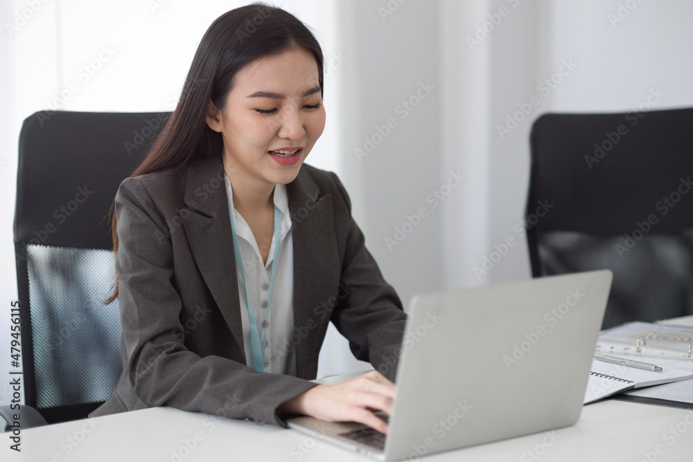 Female secretary working on her portable laptop computer Female secretary working on her portable laptop computer