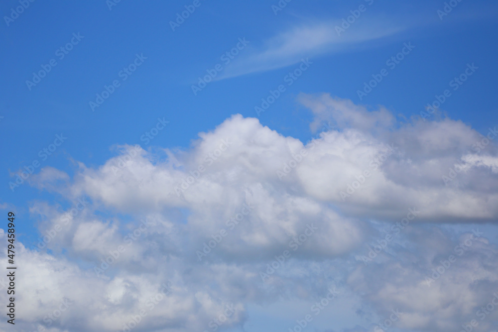 Blue sky with white clouds in the daytime background.