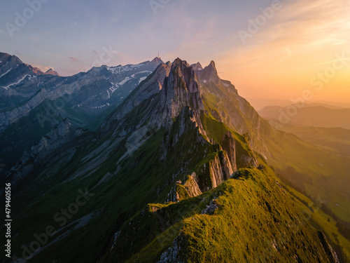 Sunset in the mountains,Schaefler Altenalptuerme mountain ridge swiss Alpstein alpine Appenzell Innerrhoden Switzerland, a steep ridge of the majestic Schaefler peak in the Alpstein mountain photo