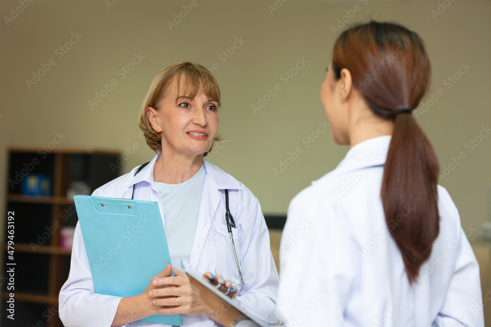 Two mature smiling doctors having discussion. Representative pharmaceutical discussing case after positive result with happy doctor. Two mature smiling doctors having discussion. Representative pharmaceutical discussing case after positive result with happy doctor.