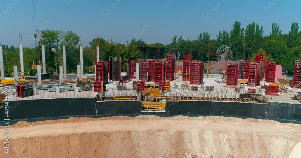 Builders make formwork at the construction site of a new stadium