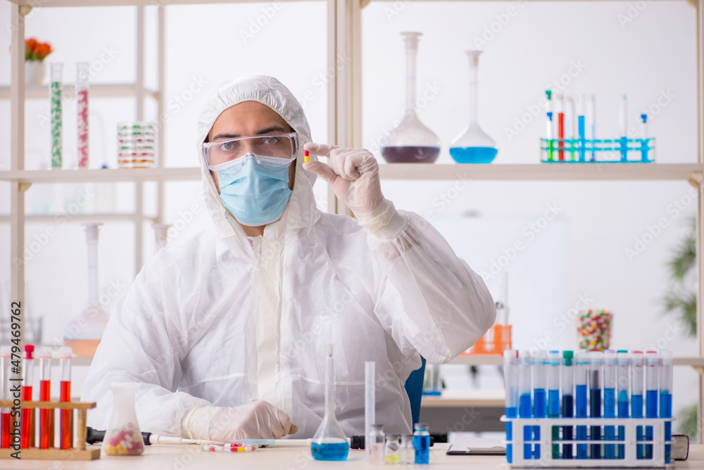 Young male chemist in drugs syntesis concept Young male chemist in drugs syntesis concept