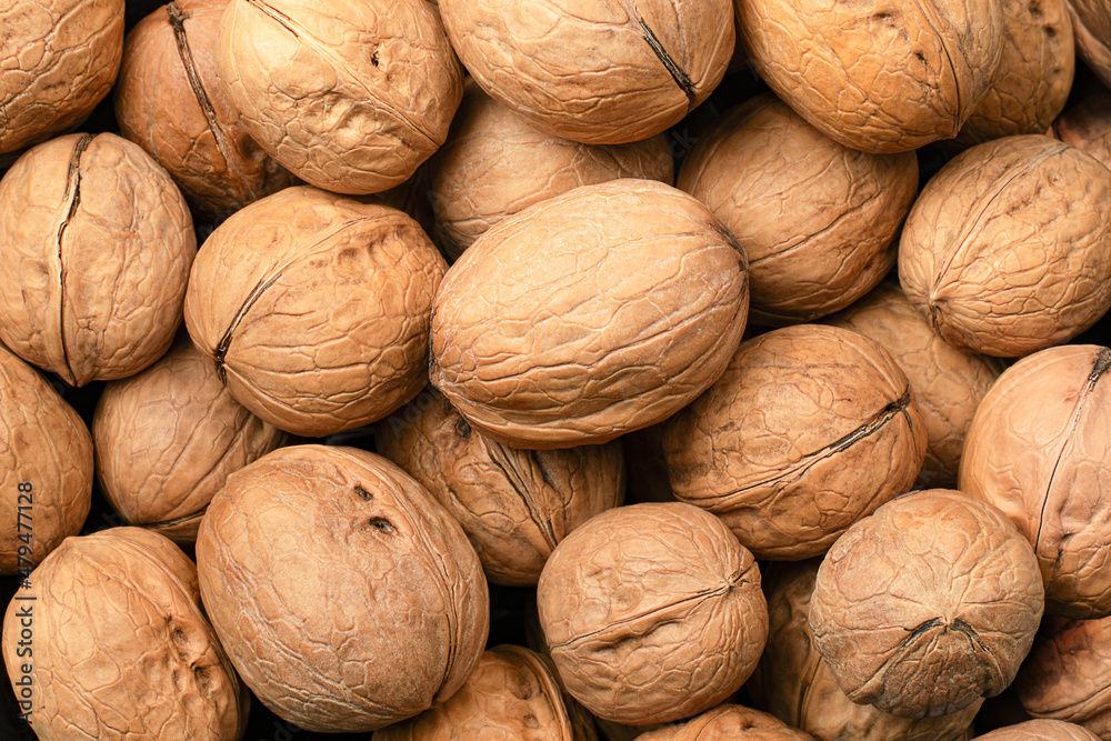 unpeeled walnut, background close up unpeeled walnut, background close up