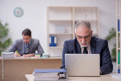 Two male employees working in the office