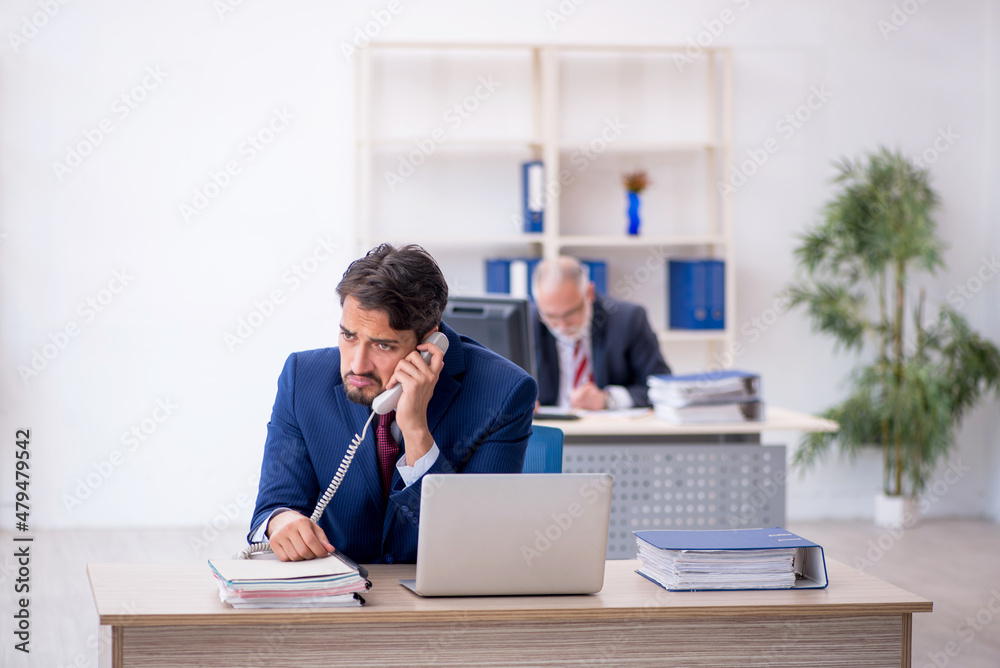 Two male colleagues working in the office Two male colleagues working in the office