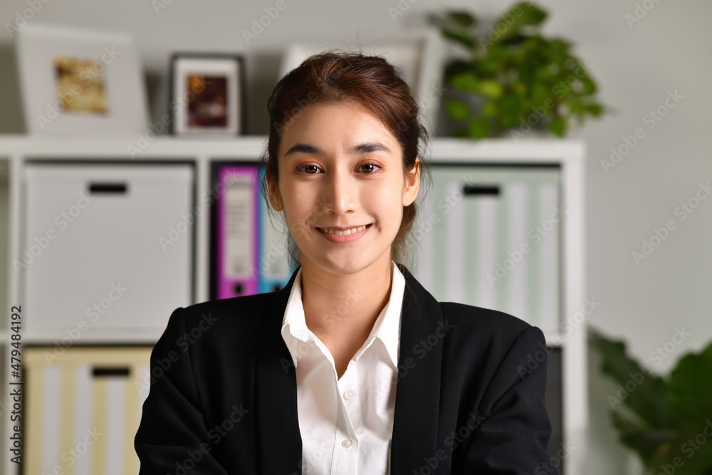 Portrait shot of happy friendly and confident Asian businesswoman making video call, looking at camera and talking, discussing strategy with partners online at home Portrait shot of happy friendly and confident Asian businesswoman making video call, looking at camera and talking, discussing strategy with partners online at home
