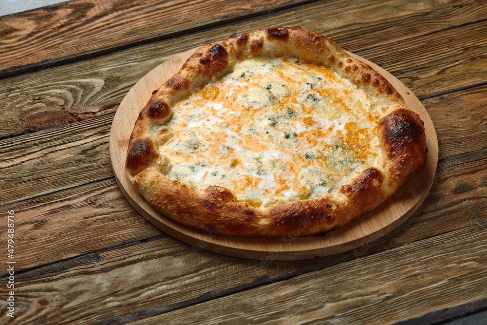 Italian Pizza Quattro formaggi. Italian pizza on wooden table background