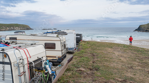 Caravanners parked on the beach with sea view photo