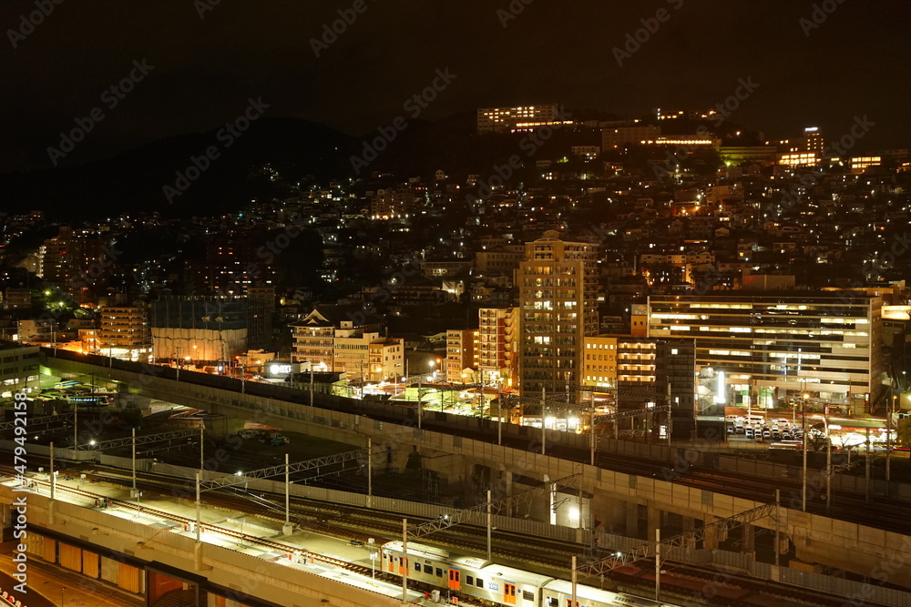Fototapeta premium Nagasaki Station and Cityscape of Nagasaki at Night in Nagasaki, Japan - 日本 長崎県 長崎駅 駅前 街並みの夜景 