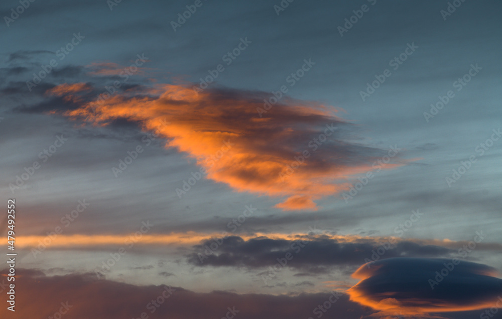Sunset sky. Detail view of some spectacular clouds in red and orange color.