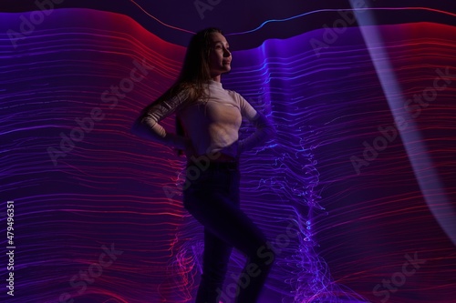 Positive young woman disco neon lines luxury fashion studio model unaltered