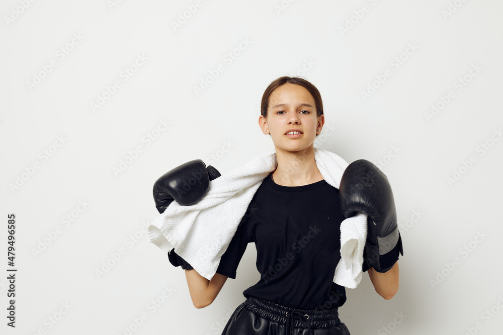 athletic woman in boxing gloves in black pants and a T-shirt isolated background athletic woman in boxing gloves in black pants and a T-shirt isolated background