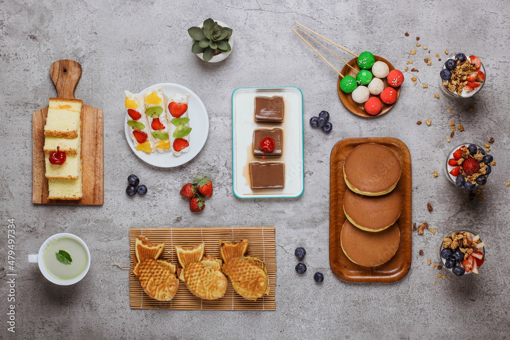 Flat lay composition of assorted Japanese desserts isolated on cement background