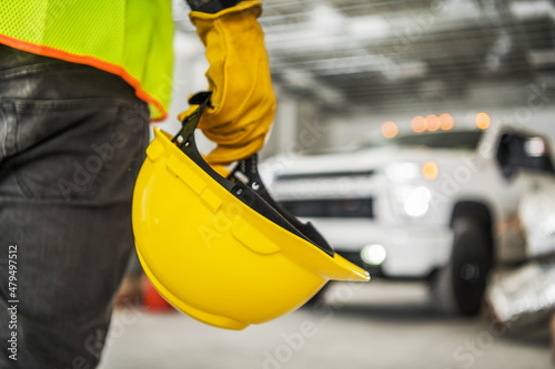 Construction Worker with Yellow Hard Hat in His Hand photo