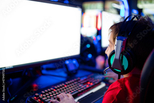 Children addicted to entertaining industry playing video games on computer in free time.