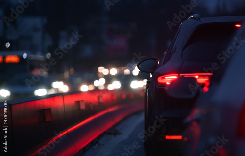 Cars staying in the morning traffic. Traffic jam on the streets of Bucharest, detail with the LED rear car light.