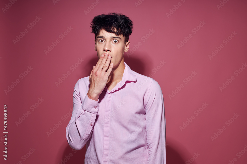 A young man posing fashion pink shirt modern style pink background unaltered A young man posing fashion pink shirt modern style pink background unaltered