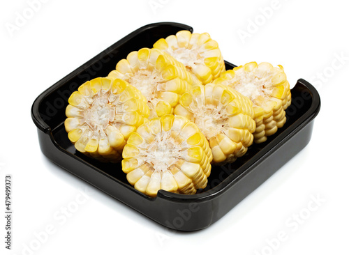 Sweet corn in blsck dish isolate on white background, shabu, hot pot ingredients. photo