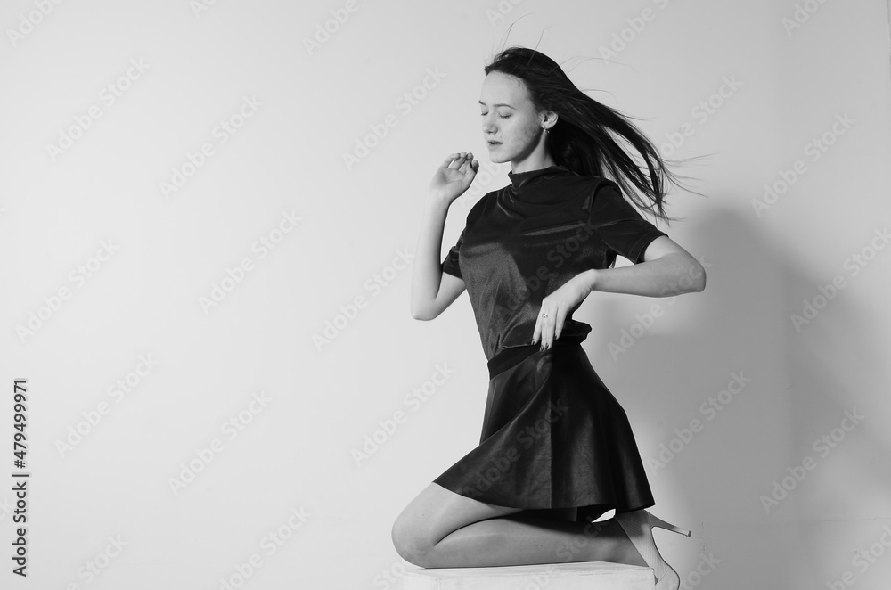 Fashion model with long hair in white shirt and tie on white background. Fashion model with long hair in white shirt and tie on white background.