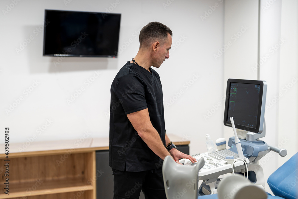 Gynecologist using medical scanner in hospital Gynecologist using medical scanner in hospital