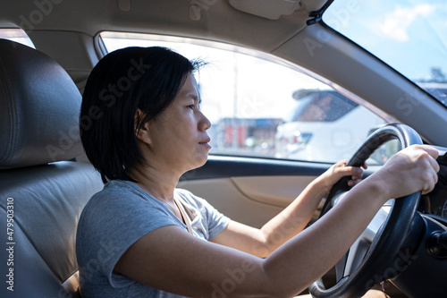 Female Asian driver fasten seatbelt and driving a car in highway for travel a vacation trip © tuastockphoto