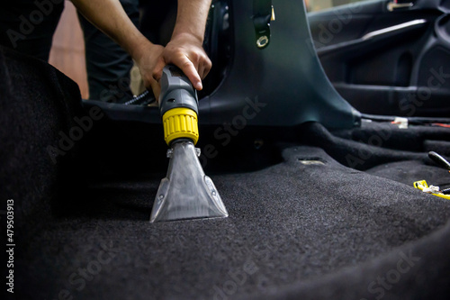 Dry cleaning of car interior with vacuum cleaner. car dry cleaning