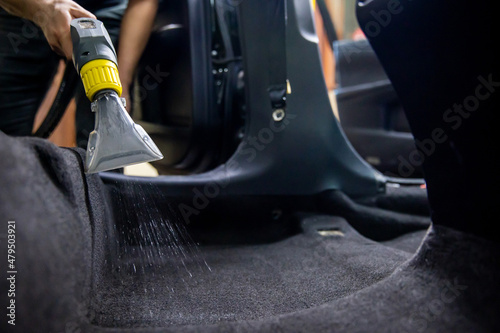 Dry cleaning of car interior with vacuum cleaner. car dry cleaning