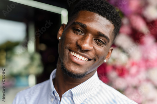 Happy young man with stud earrings photo