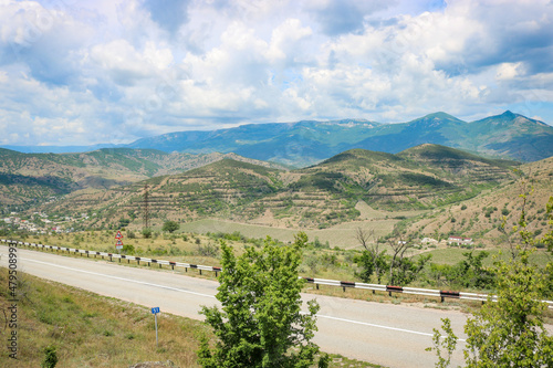 View from the highway to the mountain plateau Karabi-Yayla. Crimean landscape with mountains, vineyards and blue sky with cirrus clouds.