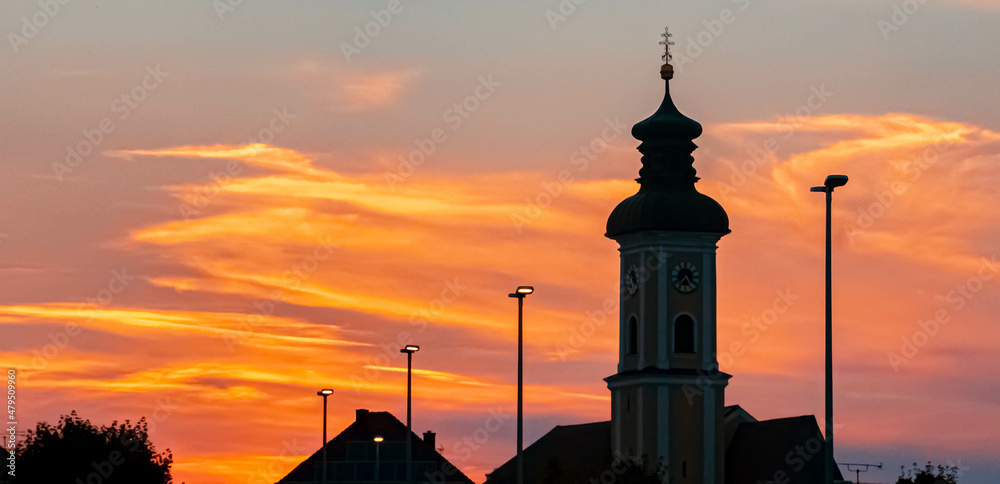 Beautiful sunset with a church silhouette at Eichendorf, Bavaria, Germany Beautiful sunset with a church silhouette at Eichendorf, Bavaria, Germany
