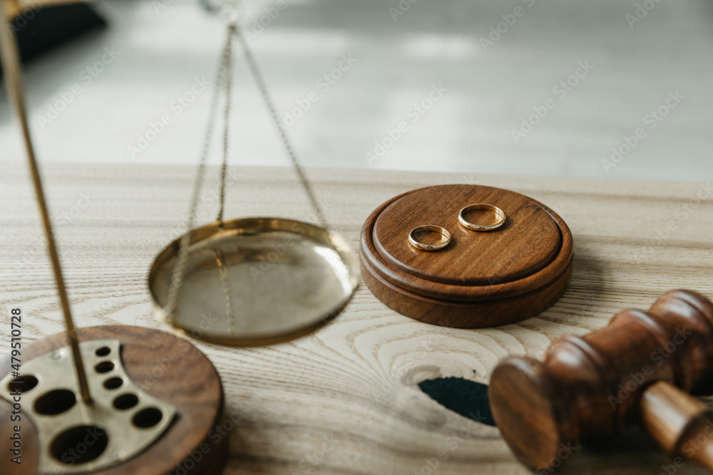 Divorce concept. Judge gavel and wedding rings. Top view