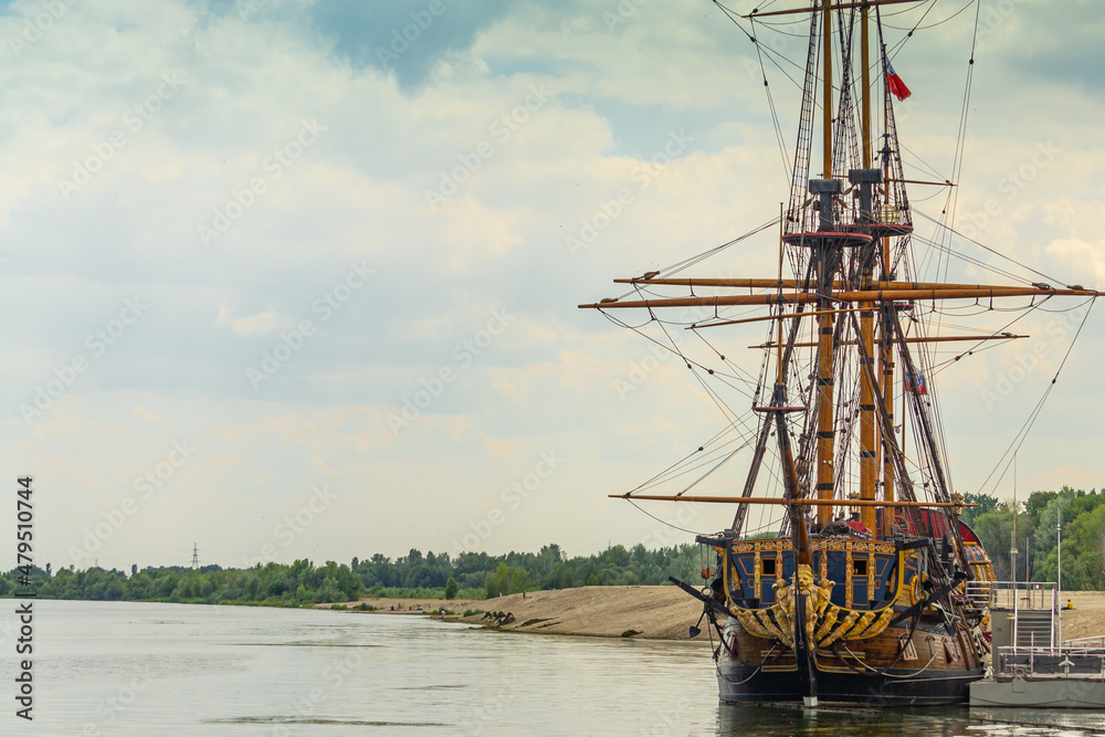 Fototapeta premium Voronezh, Russia, June 11, 2019. People on waterfront look at ship Goto Predistication moored at pier of Admiralty Square. Copy of warship designed by Peter 1.