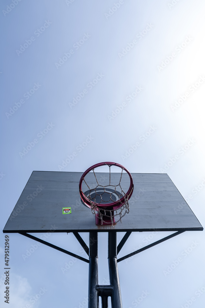 Low angle view of basketball hoop under the morning sunlight Low angle view of basketball hoop under the morning sunlight