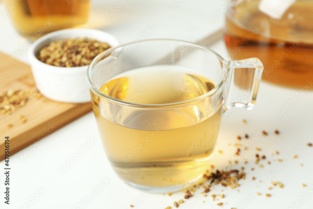 Concept of hot drink with buckwheat tea on white background Concept of hot drink with buckwheat tea on white background