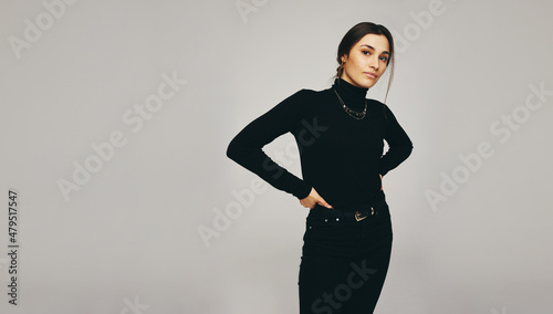 Slika na platnu Confident young woman looking at the camera in a studio