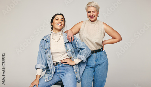 Best friends wearing denim jeans in a studio photo