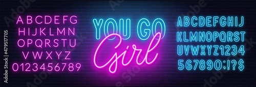 You go girl neon lettering on brick wall background.