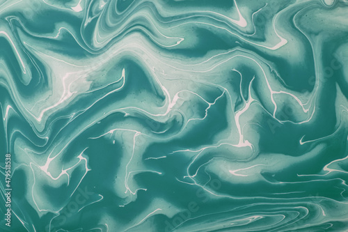 Abstract fluid art background cyan and white colors. Liquid marble. Acrylic painting with green gradient