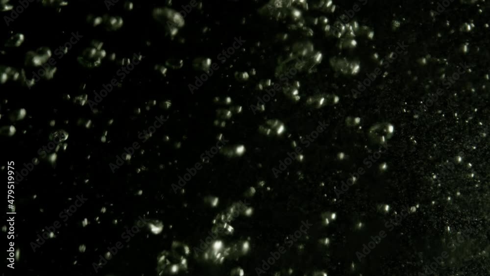 Abstract background with water bubbles as in sparkling water. Water is poured into a glass and bubbles appear, slow motion video. Abstract background with water bubbles as in sparkling water. Water is poured into a glass and bubbles appear, slow motion video.