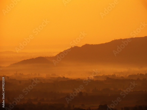 Amazing Sunrise Over Misty Landscape. Scenic View Of Foggy Morning Sky With Rising Sun Above Misty Forest © khlongwangchao